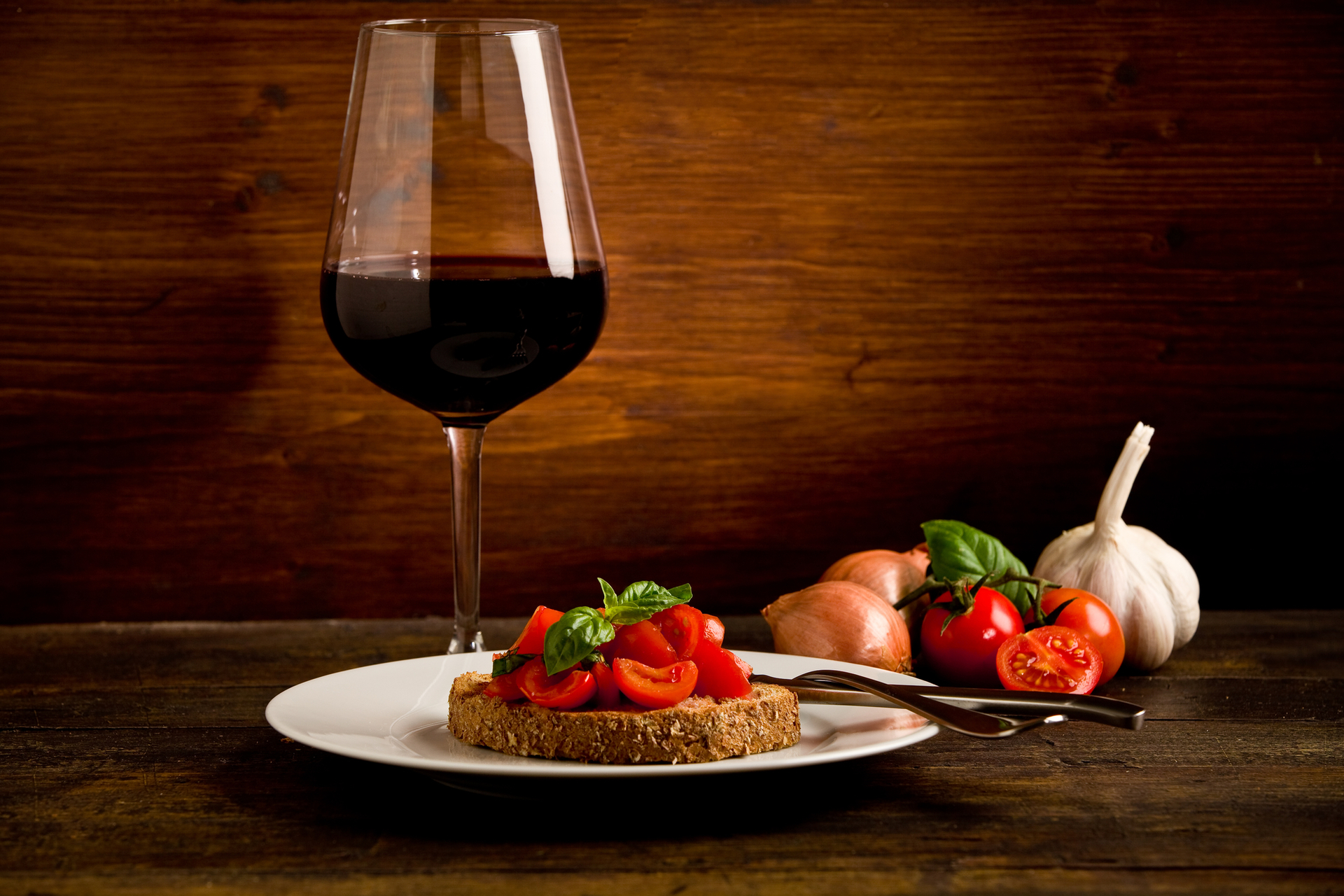 Bruschetta appetizer with corvina wine on wooden table