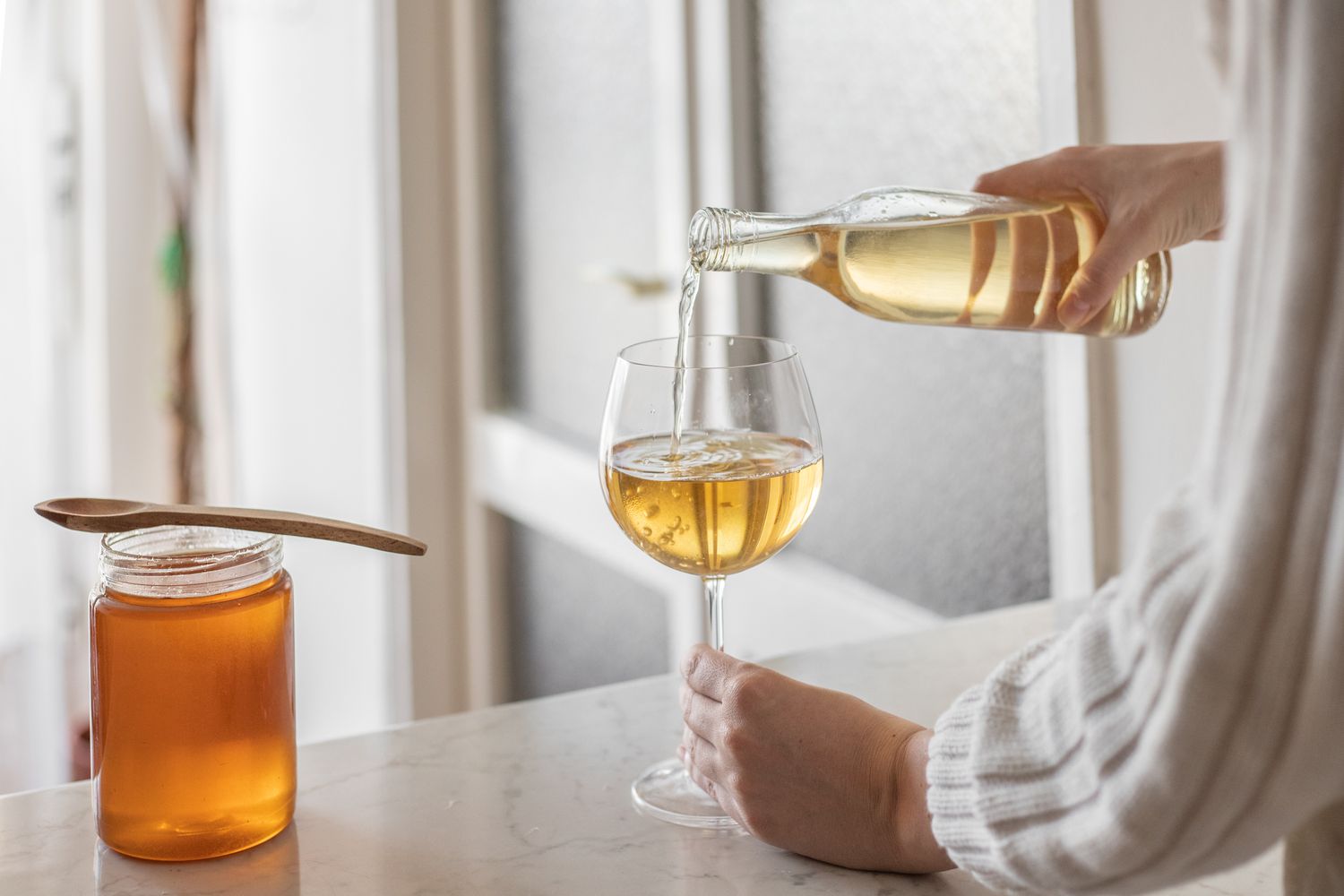 A glass of rich amber honey wine, exemplifying the traditional and natural essence of the beverage, symbolizing the focus keyword 'honey wine'.