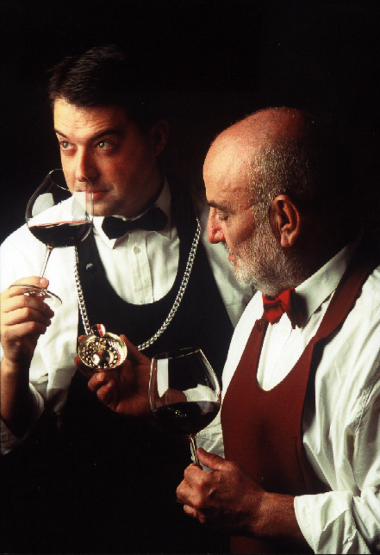 A sommelier wearing a tastevin necklace, illustrating the elegance and tradition of this iconic symbol in the world of fine wine.